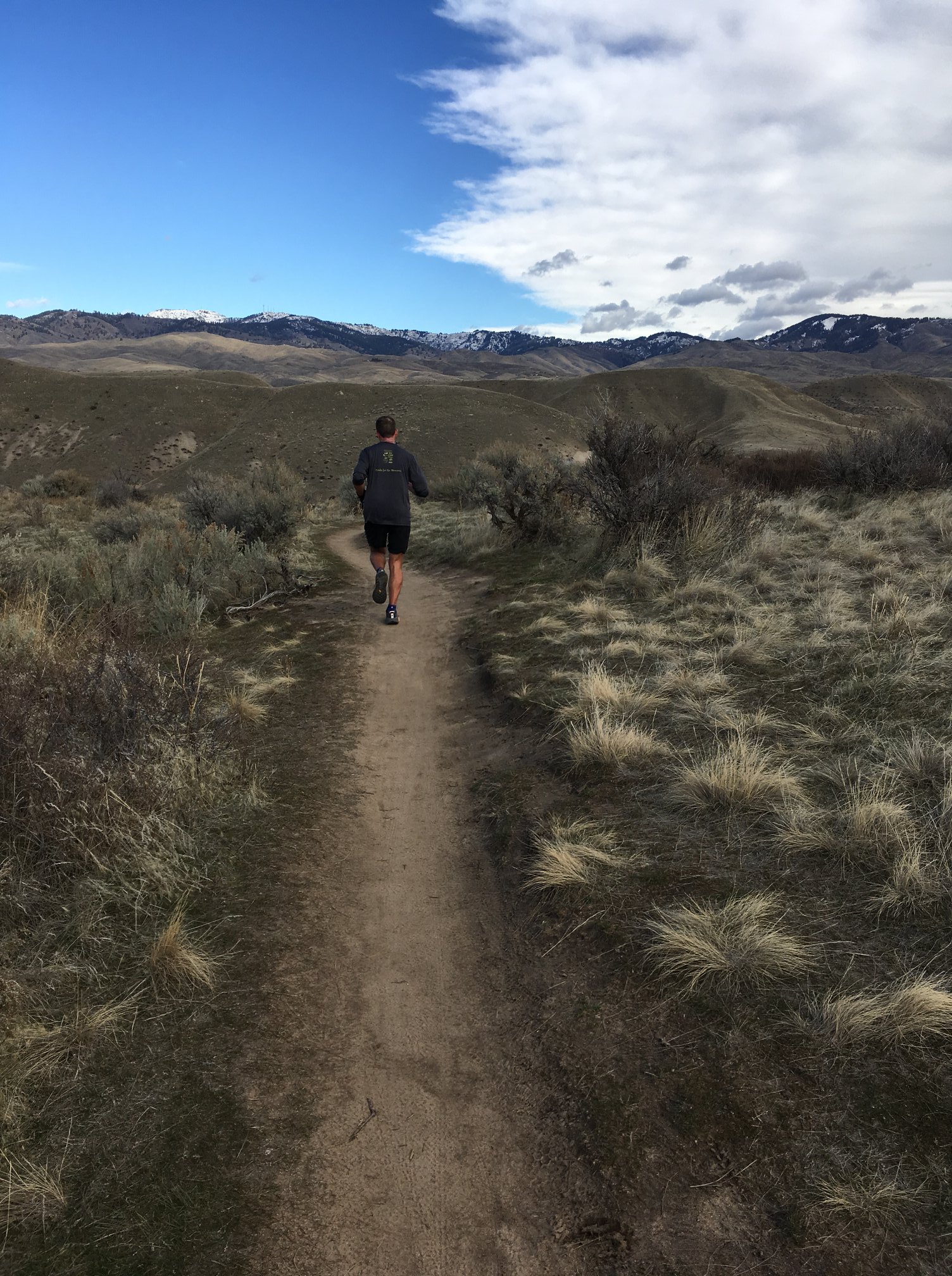 Runner on trail in foothills. 